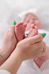 Mother hands with baby foot