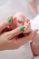 Mother hands with baby foot