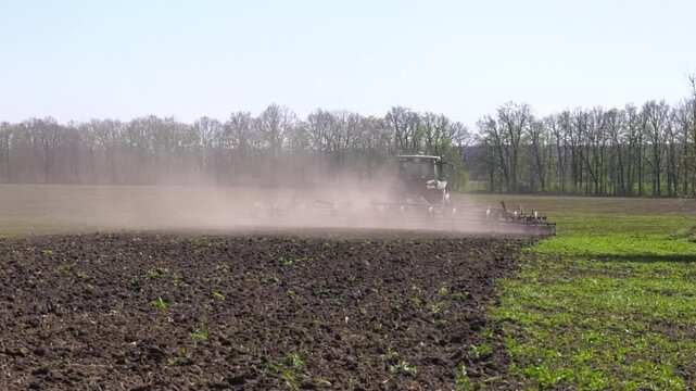 View of tractor, combine plowing cultivating agriculture field