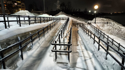 A ramp for wheelchair users in winter in the snow. Difficult movement in winter in Russia