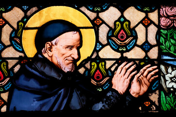 Very colorful old stained glass of Saint Vincent de Paul. Saint of the Roman Catholic Church.