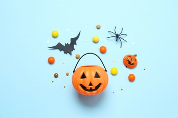 Different Halloween decorations including pumpkins, bats, spiders, confetti on color background