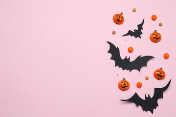 Different Halloween decorations including pumpkins, bats, spiders, confetti on color background