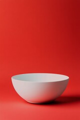 Simple white bowl on a vibrant red background capturing modern minimalism