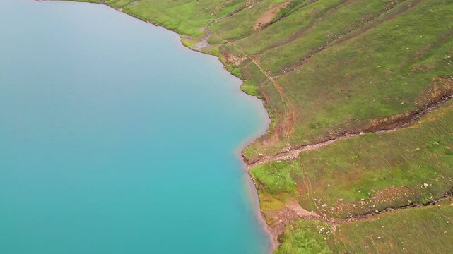 Dudipatsar Lake, a pristine blue alpine lake nestled among the snow-capped mountains of Pakistan's Kaghan Valley.