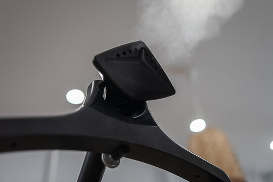 Close-up of a steaming clothes steamer in a shop