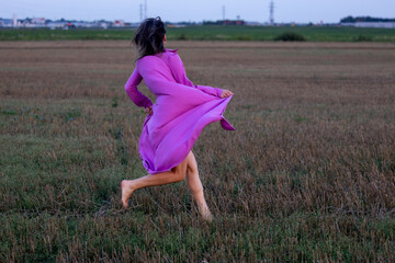 Young Woman's Dance of Freedom in Windy Fields: The Harmony of Femininity and Freedom