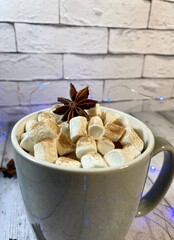 Cozy winter photo with coffee and marshmallow and garland christmas new year holiday home 