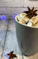 Cozy winter photo with coffee and marshmallow and garland christmas new year holiday home 