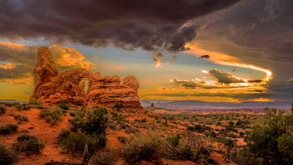 Turret Arch, located in Arches National Park, Utah, is a striking natural formation known for its unique, turret-like shape. At sunset, the arch glows with vibrant hues of red and orange © hpbfotos