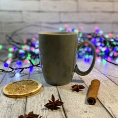 Cozy winter photo with cup of coffee and garland christmas new year mood december 