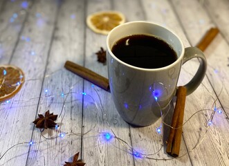Cozy winter photo with cup of coffee and garland christmas new year mood december 