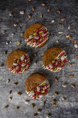 Homemade cookie with raspberry and pistachio gray background