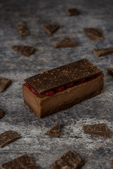Mini chocolate ingot cake with raspberries on a grey background