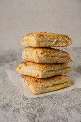 Homemade cheese scone on grey background