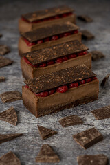 Mini chocolate ingot cake with raspberries on a grey background