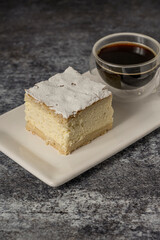Ricotta cake with coffee on a grey background