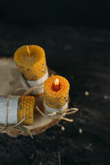 Handmade Honeycomb Candles Glowing On Rustic Wooden Slab
