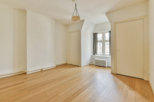 Bright and empty room with hardwood floors and vintage charm