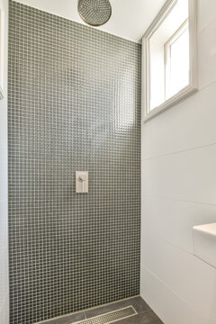 Modern bathroom with a tiled shower and rain showerhead