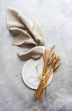 Simple autumnal table setting with elegant wheat decoration