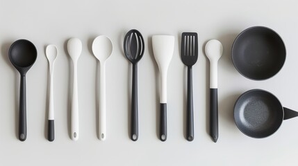 Flat lay of modern kitchen utensils on a white background, emphasizing a sleek and minimalist design
