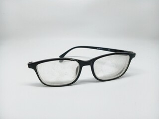 broken glasses with only one handle on a white background