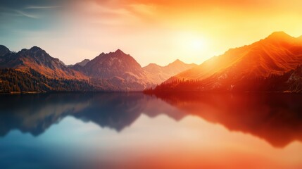 Stunning sunset over tranquil lake and mountains, reflecting vibrant colors on calm water.