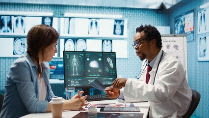 Medical expert specialist explaining the x ray imaging for a diagnosis, doing scan interpretation during check up consultation. Professional medic gives feedback to female client. Camera B.