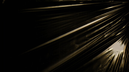 Gold metallic plastic texture over a black background. 