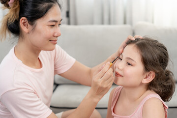 mother make up and teaching for Happy children. Girl applying makeup. Activity family, Advertisement, lifestyle , cosmetics, makeup accessories, beauty activity, beautician, talent, love beauty