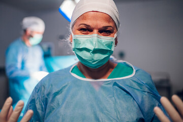 Medical professional in surgical attire standing in surgery room