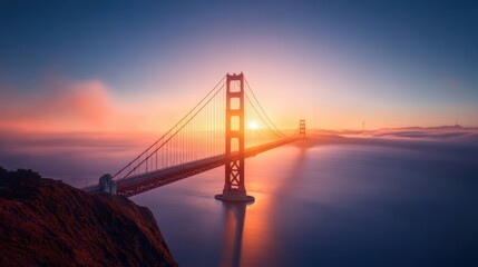 Fototapeta premium A breathtaking view of the San Francisco skyline with the iconic Golden Gate Bridge framing the setting sun, creating a fiery spectacle.