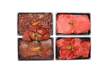 Top View of Assorted Raw Beef Steaks, Liver, and Thighs in Trays Isolated on White Background