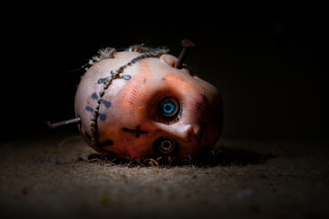 a creepy doll in a dark room, a creepy doll covered in dried blood