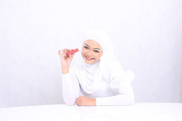 beauty makeup lips Beautiful young girl veil cheerful look at camera hand clamp tilted sideways lipstick container isolated white background. cosmetic promotion, lip care, lipstick mock up container