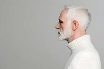 Fototapeta premium Sad senior man isolated on gray background. Studio portrait. Dementia and Alzheimer's disease concept. Memory loss awareness. Banner with copy space