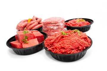 Side View of Assorted Raw Beef Cuts, Minced Meat, Sausages, and Burger Patties Isolated on White Background
