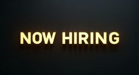 Obraz premium now hiring word lettering with yellow glow on plain black dark background