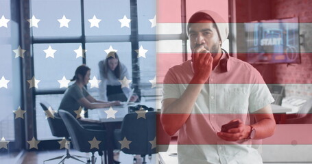 Image of flag of usa over diverse business people in office