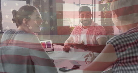 Image of flag of usa over diverse business people in office