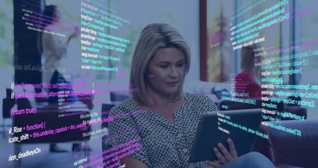 Image of data processing over happy caucasian businesswoman using tablet at office