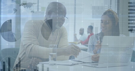 Naklejka premium Image of financial data processing over diverse business people in office