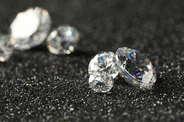 Beautiful dazzling diamonds on dark shiny background, closeup