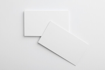 Blank business cards on light grey background, top view. Mockup for design
