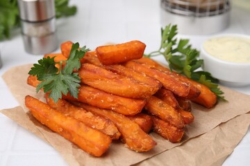 Sweet potato fries and parsley on table, closeup