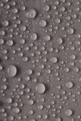 Fototapeta premium Water drops on gray background, top view