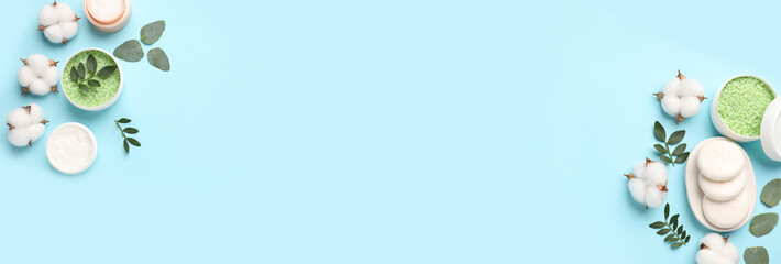 Cosmetic products and cotton flowers on light blue background, flat lay. Banner design with space for text