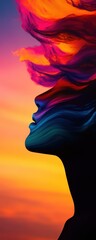 Silhouette of a woman with colorful hair against a vibrant sunset background.