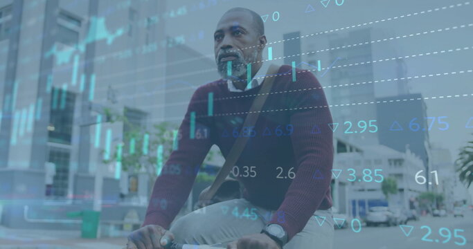 Image of financial data processing over african american man riding bike in city - Powered by Adobe